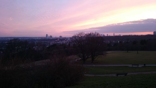 Scenic view of field against sky at sunset