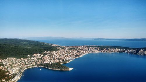 High angle view of sea and cityscape against sky