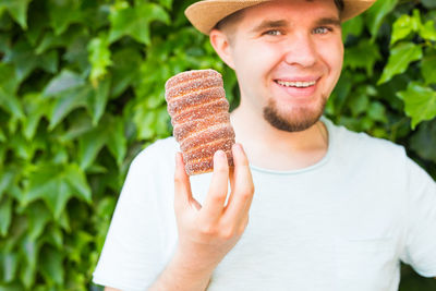 Portrait of a smiling young man holding ice cream