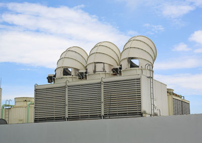 Low angle view of factory against sky