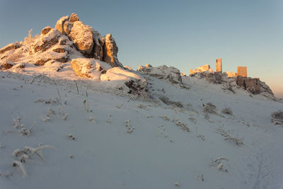 Scenic view of land against clear sky during winter