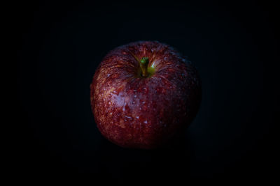 Close-up of apple against black background