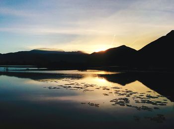 Scenic view of lake against sky during sunset