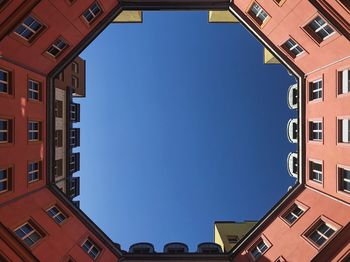 Low angle view of buildings against blue sky