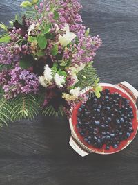 Bunch of flowers and blueberry cake on table