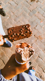 High angle view of hand holding ice cream