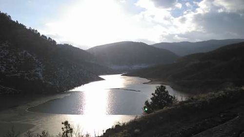 Scenic view of lake and mountains against sky