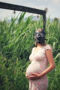 Rear view of woman standing on field