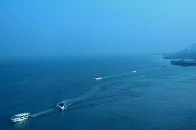 High angle view of sea against blue sky