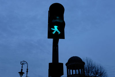 Low angle view of road sign against clear blue sky