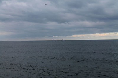 Scenic view of sea against cloudy sky