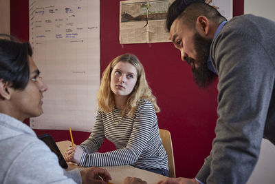 Teacher talking to students in class