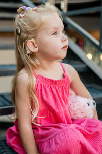 Close-up of cute girl looking away