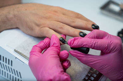 Cropped hands of man working on table