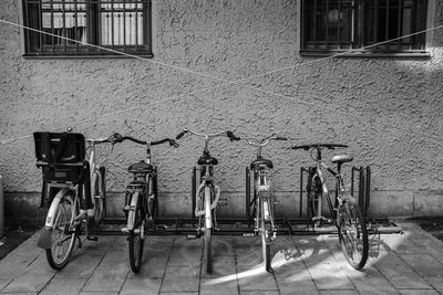 Bicycle parked on sidewalk by building