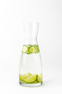 Glass of juice against white background