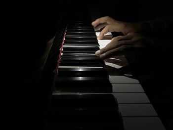 Close-up of man playing piano