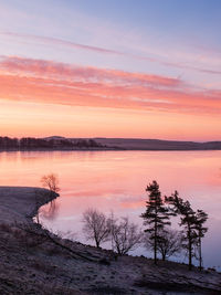 Scenic view of lake against sky during sunset