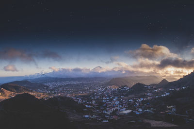 Aerial view of city against sky at night