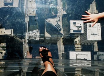 Woman photographing through smart phone in city