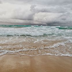 Scenic view of sea against cloudy sky