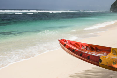 Boat on beach against sky