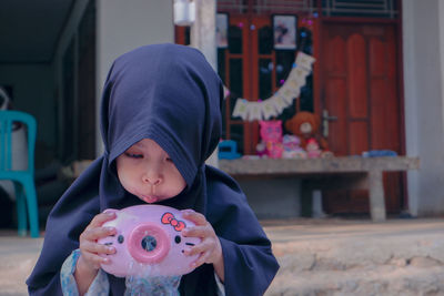 Portrait of young woman with her new toy