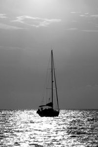 Sailboat sailing on sea against sky