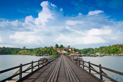 Pier over river against sky