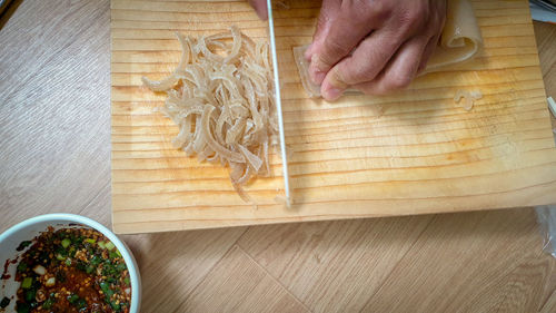 Close-up of person preparing food on cutting board