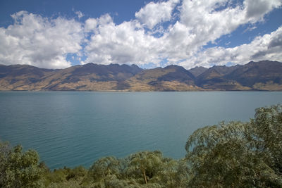 Scenic view of lake and mountains against sky