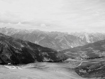 View of snow covered landscape against mountain range