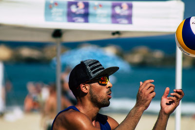 Portrait of young man looking at swimming pool