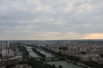 High angle view of river by buildings in city against sky