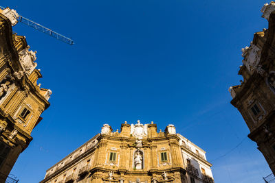 Low angle view of building against blue sky