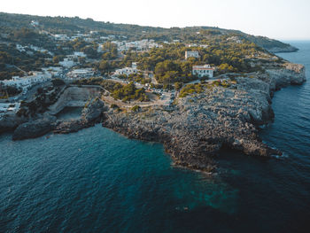 High angle view of rocks on sea shore against sky