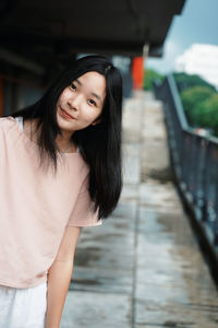 Portrait of beautiful young woman standing outdoors