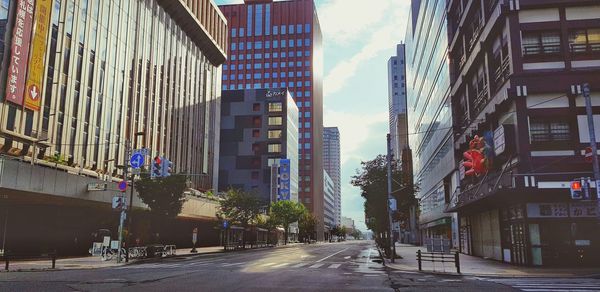 Street amidst buildings in city against sky