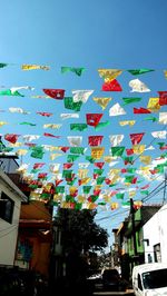 Low angle view of flags hanging against sky