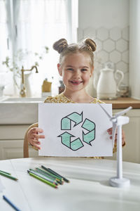 Portrait of smiling girl on table