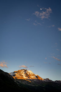 Scenic view of mountains against blue sky