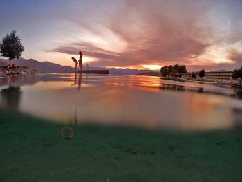 Scenic view of lake at sunset
