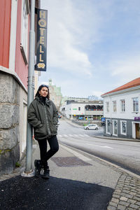 Full length of man standing on road in city
