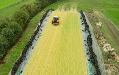 High angle view of vehicles on road amidst field