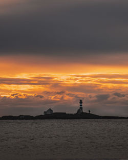 Scenic view of sea against orange sky