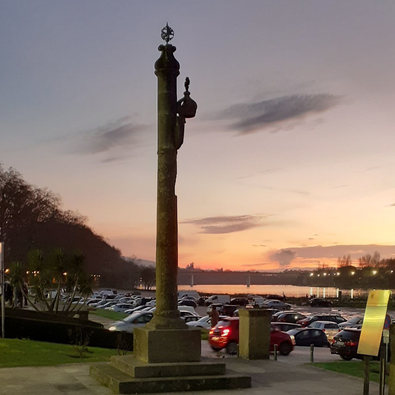 sky, sunset, architecture, nature, cloud - sky, no people, orange color, built structure, architectural column, building exterior, lighting equipment, outdoors, city, street light, street, water, tall - high, travel destinations, dusk