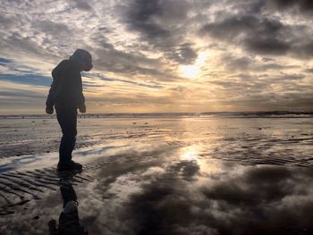 Scenic view of sea against cloudy sky