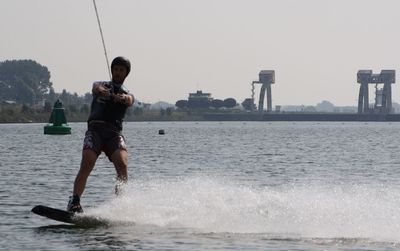 Full length of man on sea against clear sky