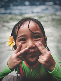 Portrait of happy girl balinese holding flower and smile