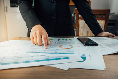 Low section of man working on table